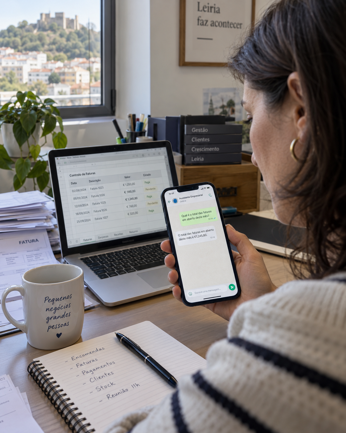 Empresária numa retaguarda de escritório em Leiria a olhar para uma resposta com um valor de IVA no assistente de WhatsApp no telemóvel