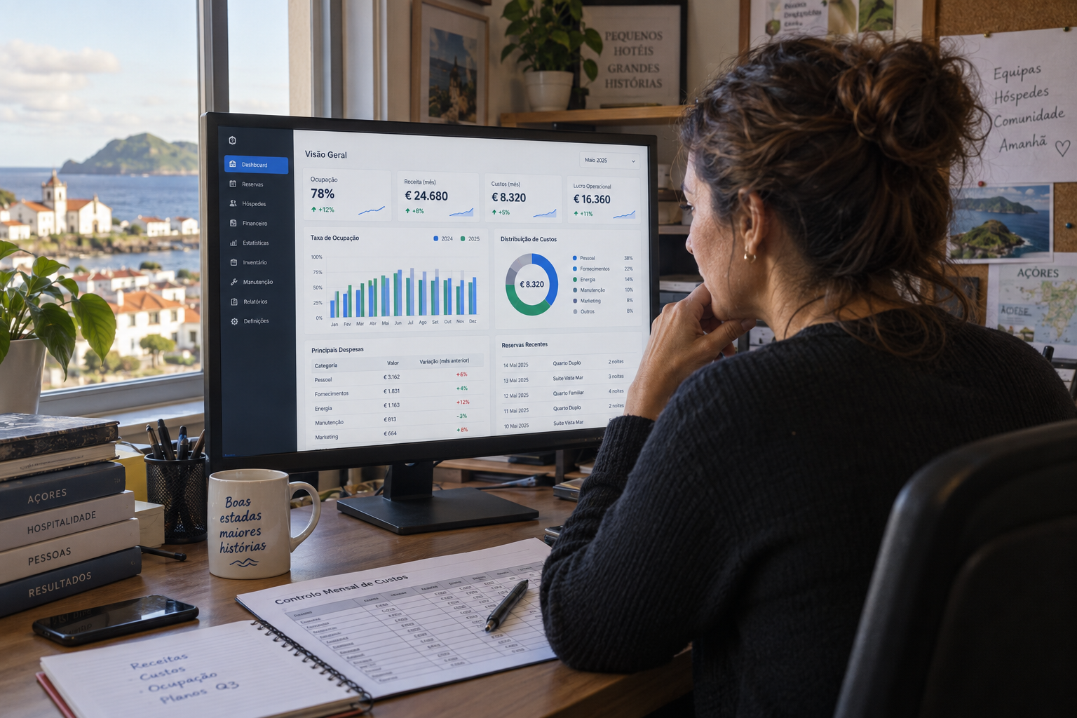 Gestora de operações de um pequeno hotel açoriano a rever no monitor o painel financeiro do ERP no fim do dia